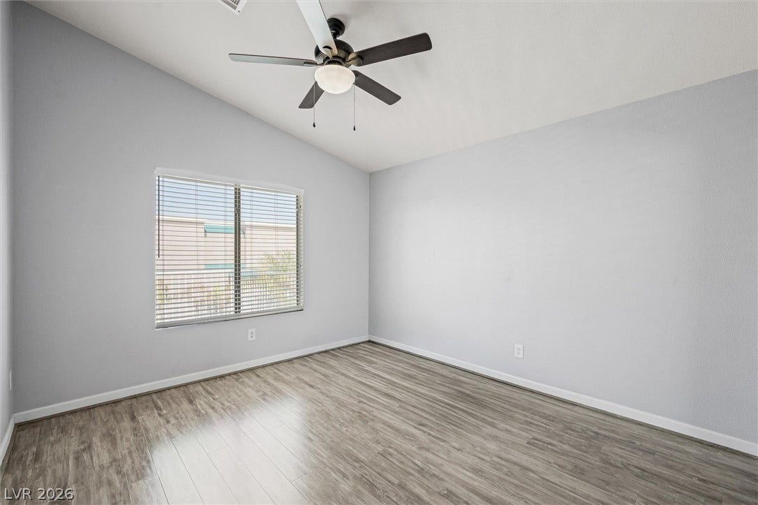 1584 Bozeman Drive, Henderson, NV 89012 High vaulted ceilings and wood-style flooring elevate this versatile bedroom.