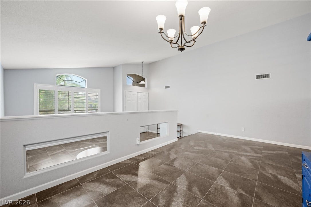 1584 Bozeman Drive, Henderson, NV 89012 Polished tile flooring and vaulted ceilings define this airy, open upper-level living space.