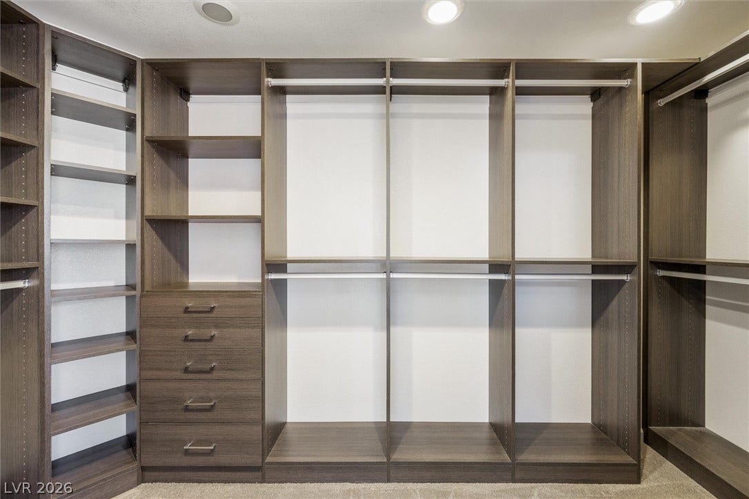 1584 Bozeman Drive, Henderson, NV 89012 Custom built-in shelving and ample hanging space define this organized walk-in closet.