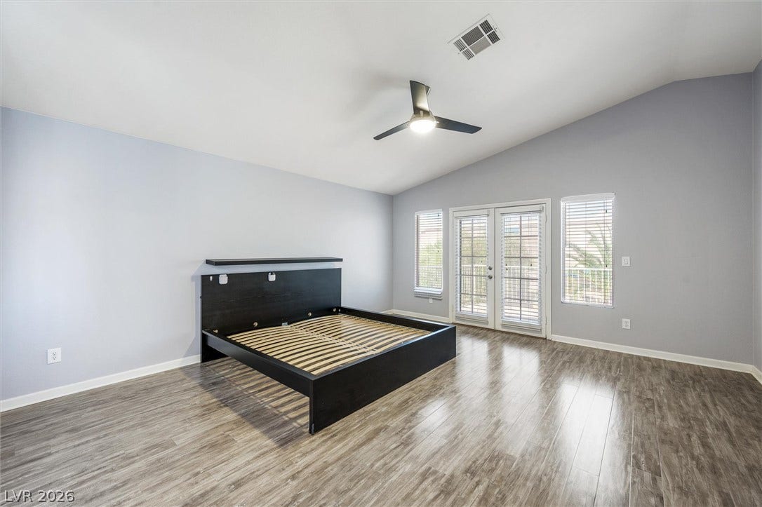 1584 Bozeman Drive, Henderson, NV 89012 Vaulted ceilings and wood-style flooring elevate this comfortable space opening to a private balcony.