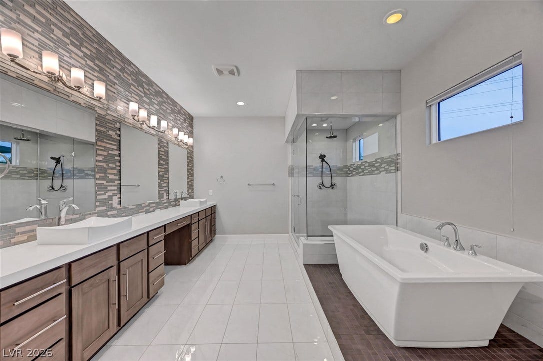 A freestanding tub and walk-in shower elevate this spacious contemporary bathroom.