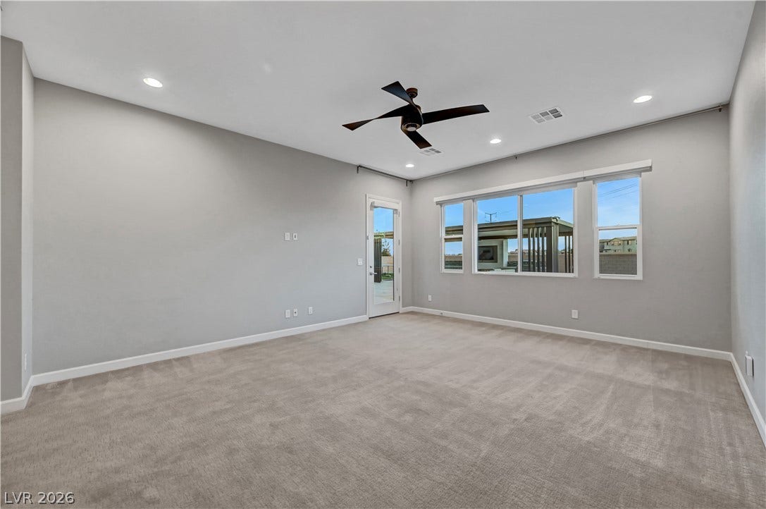 Generous windows fill this plush carpeted space with abundant natural light.