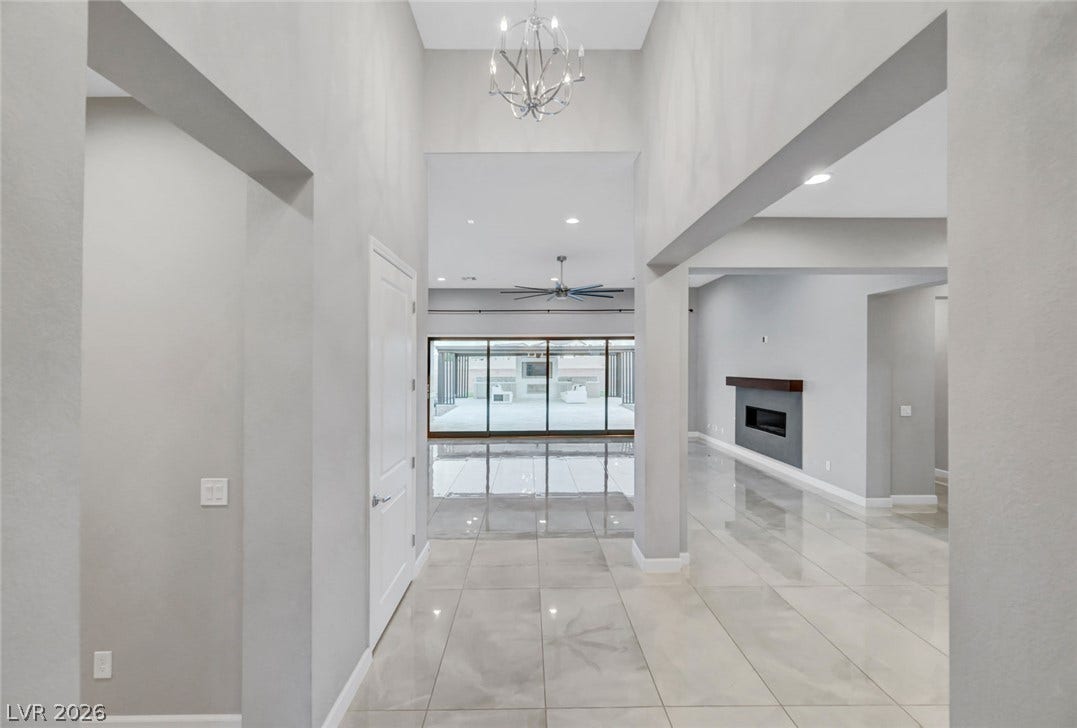 Gleaming tile floors and soaring ceilings define this modern open-concept entryway.