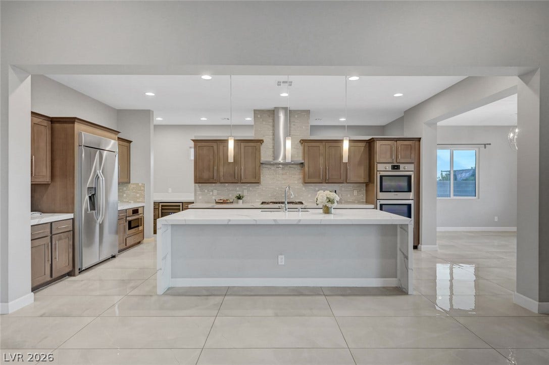 Polished tile flooring and clean lines define this modern open-concept kitchen.