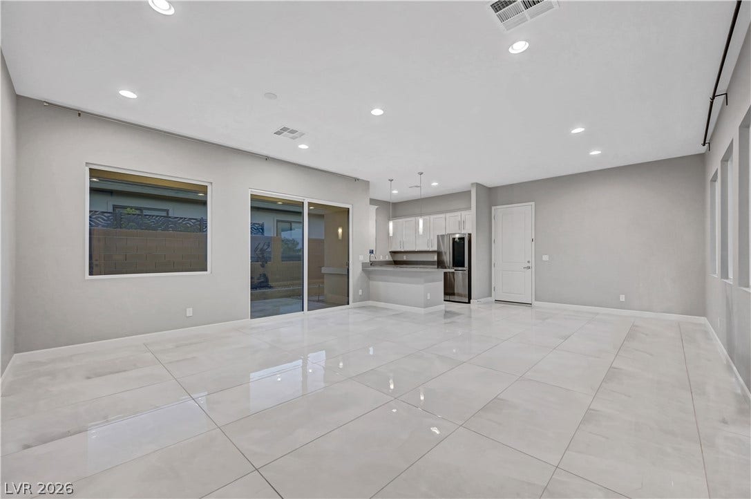Gleaming tile floors and a seamless open layout connect the main living space and kitchen.