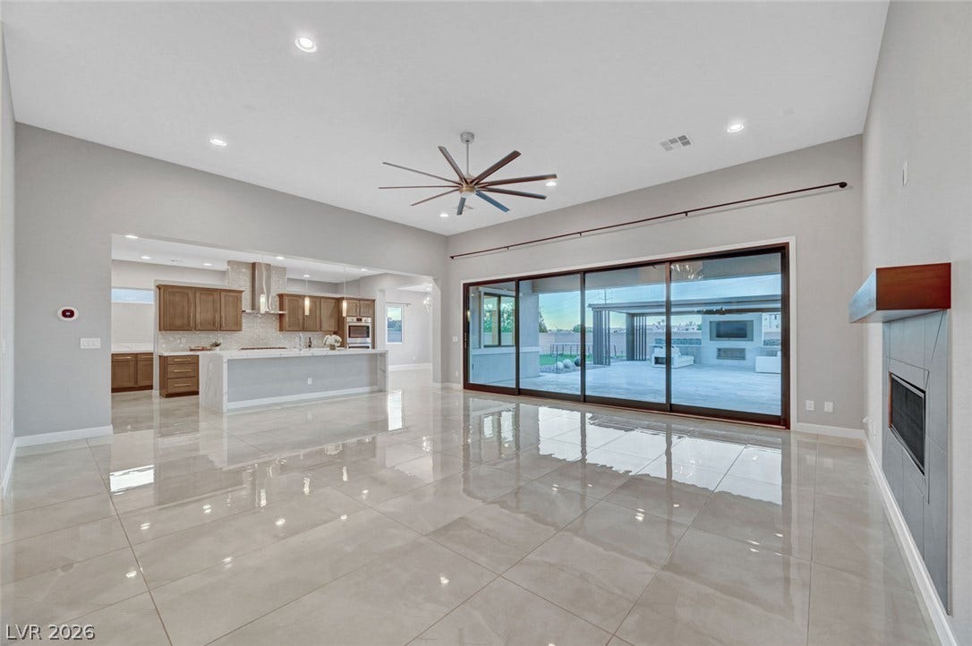 Gleaming tile floors and massive sliding glass doors define this open-concept main living space.