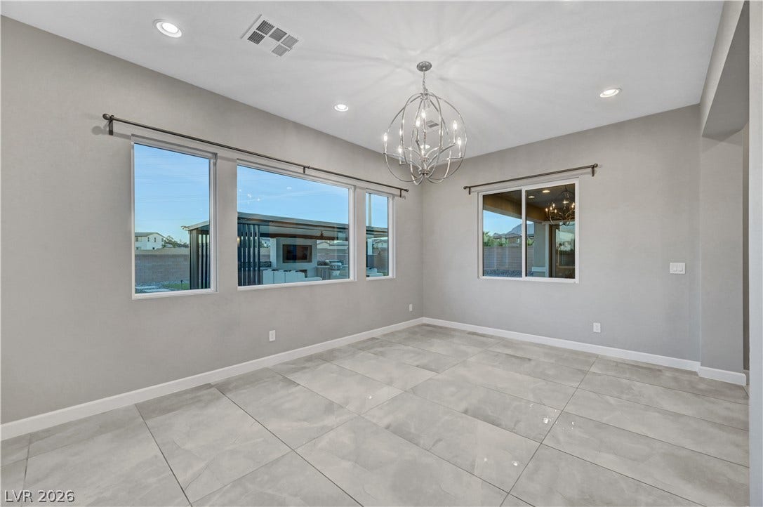 Polished tile flooring and multi-panel windows define this versatile dining area.