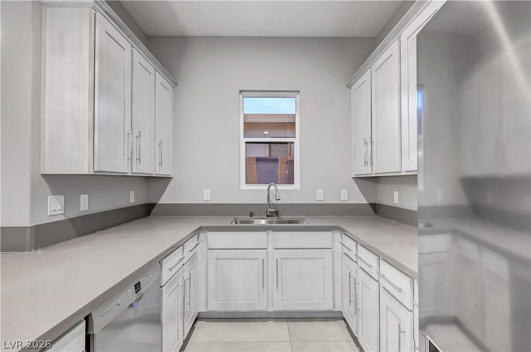 Ample counter space and classic cabinetry define this functional u-shaped kitchen layout.