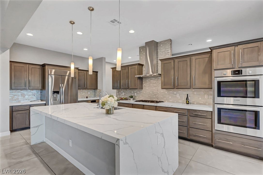 Premium stone countertops and sleek cabinetry define this modern kitchen space.