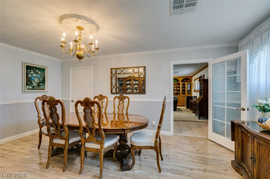 661 Burton Street, Henderson, NV 89015 Elegant crown molding complements classic wood flooring in this formal dining area.