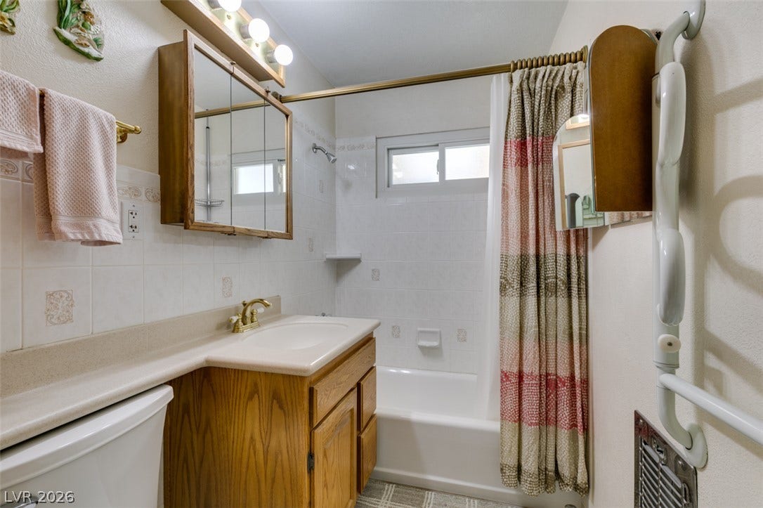 661 Burton Street, Henderson, NV 89015 A classic bathroom layout includes a built-in vanity and integrated tub and shower combination.