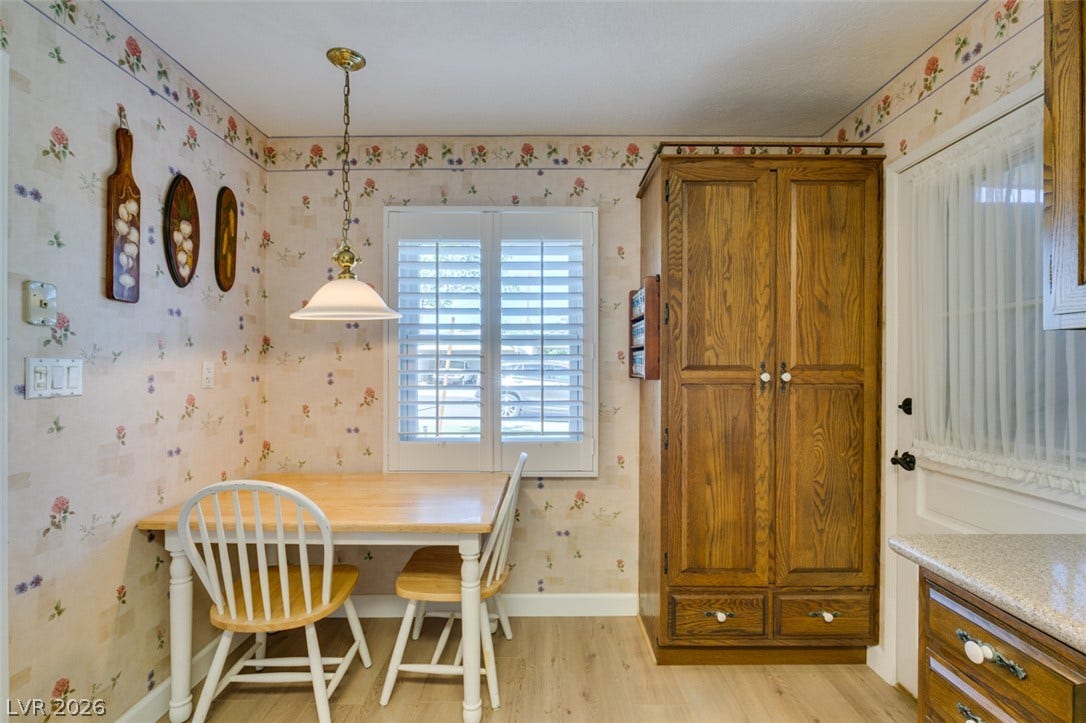 661 Burton Street, Henderson, NV 89015 Floral patterned wallpaper and plantation shutters bring classic warmth to this cozy dining nook.