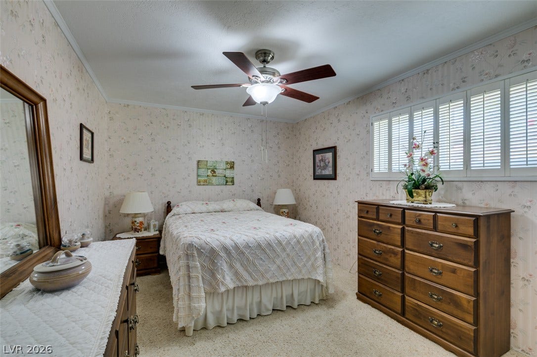 661 Burton Street, Henderson, NV 89015 Plush carpet flooring pairs with traditional wall coverings under a clean white ceiling.