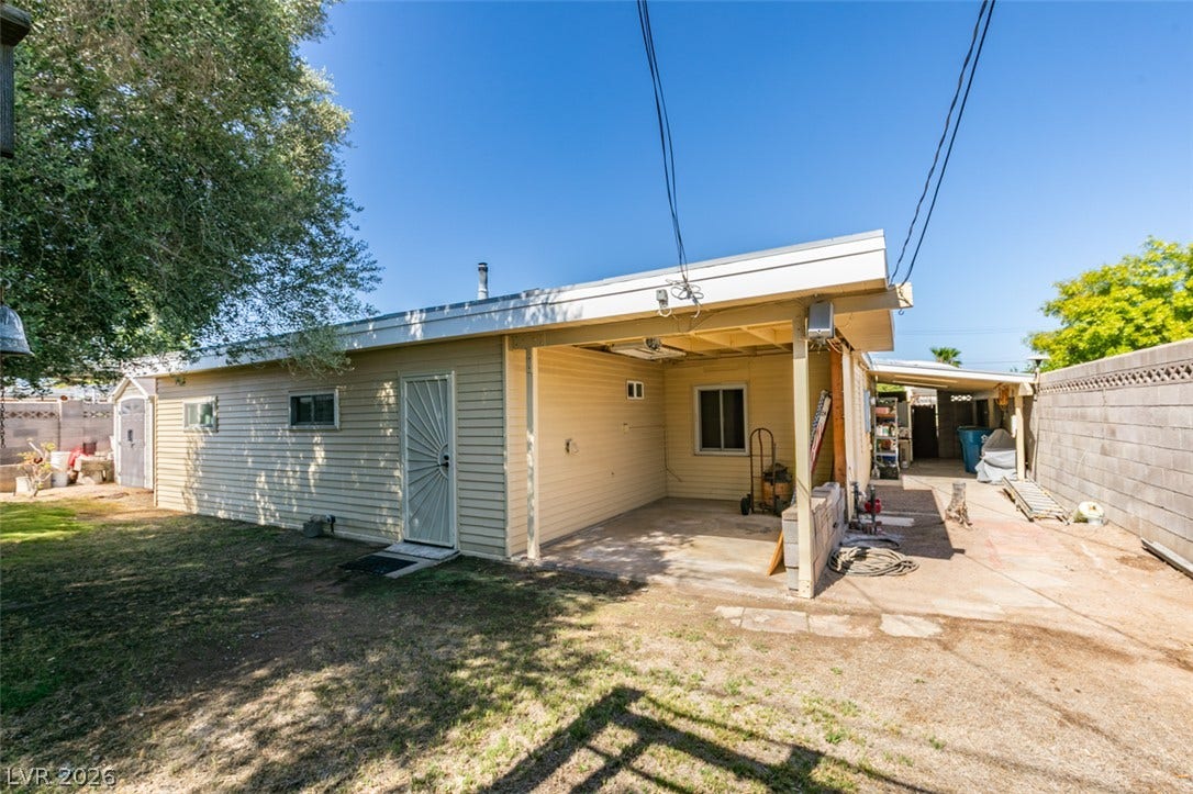 661 Burton Street, Henderson, NV 89015 An open carport and concrete patio space alongside the main structure.