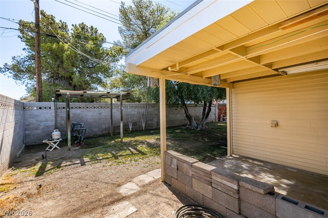 661 Burton Street, Henderson, NV 89015 A covered patio overlooks the fenced backyard complete with mature shade trees.