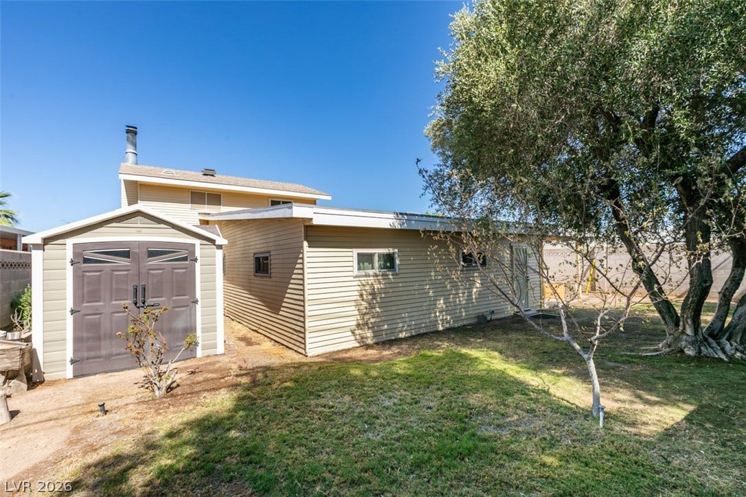 661 Burton Street, Henderson, NV 89015 A spacious backyard features a detached storage shed alongside the main residence siding.