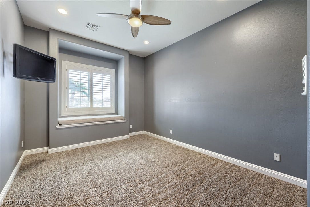2807 Richmar Avenue, Henderson, NV 89074 High ceilings and a deep window seat with built-in shutters define this versatile room.