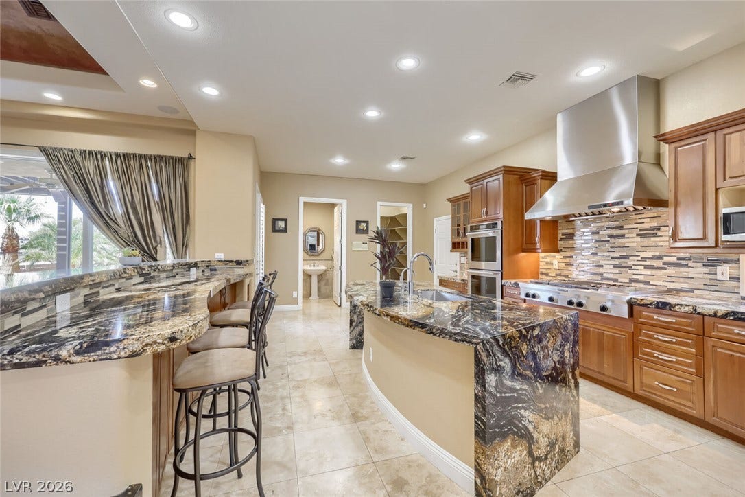 2807 Richmar Avenue, Henderson, NV 89074 Gleaming tile floors complement the richly patterned granite countertops and professional stainless steel appliances.