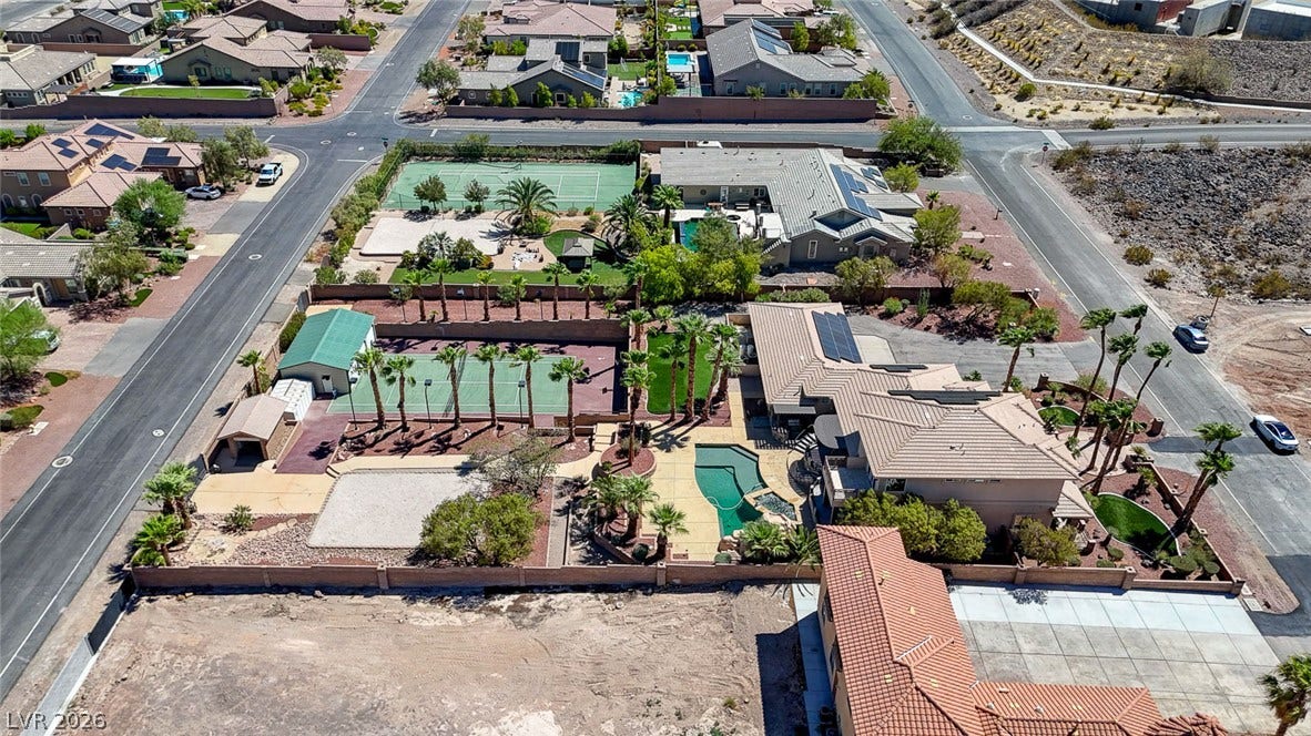 2807 Richmar Avenue, Henderson, NV 89074 An aerial perspective showcases an expansive residential estate featuring a private pool and tennis court.