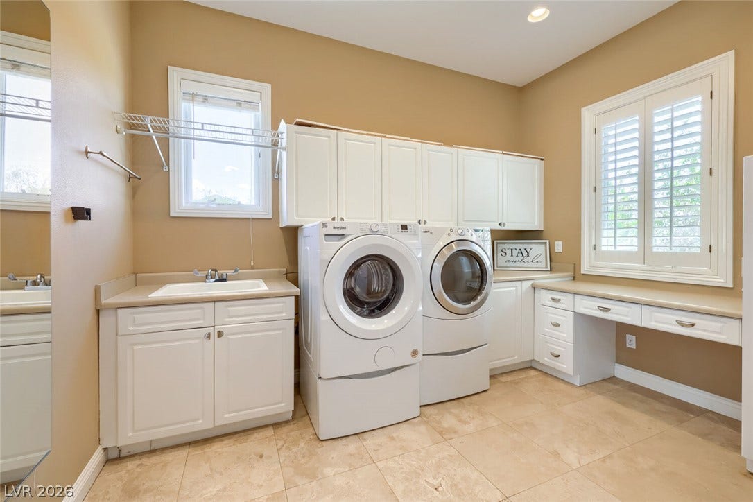 2807 Richmar Avenue, Henderson, NV 89074 Ample cabinetry, a dedicated folding desk, and a utility sink maximize this laundry workspace.