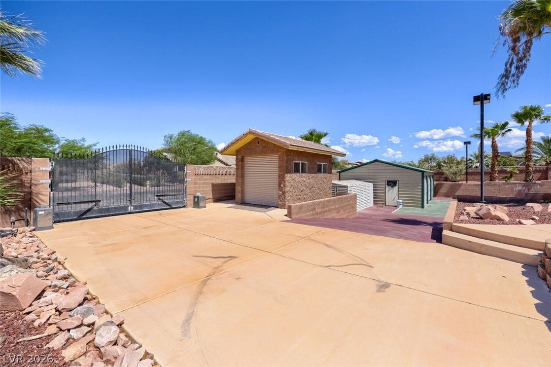 2807 Richmar Avenue, Henderson, NV 89074 A secure gated entry opens to a spacious paved driveway and multiple versatile outbuildings.