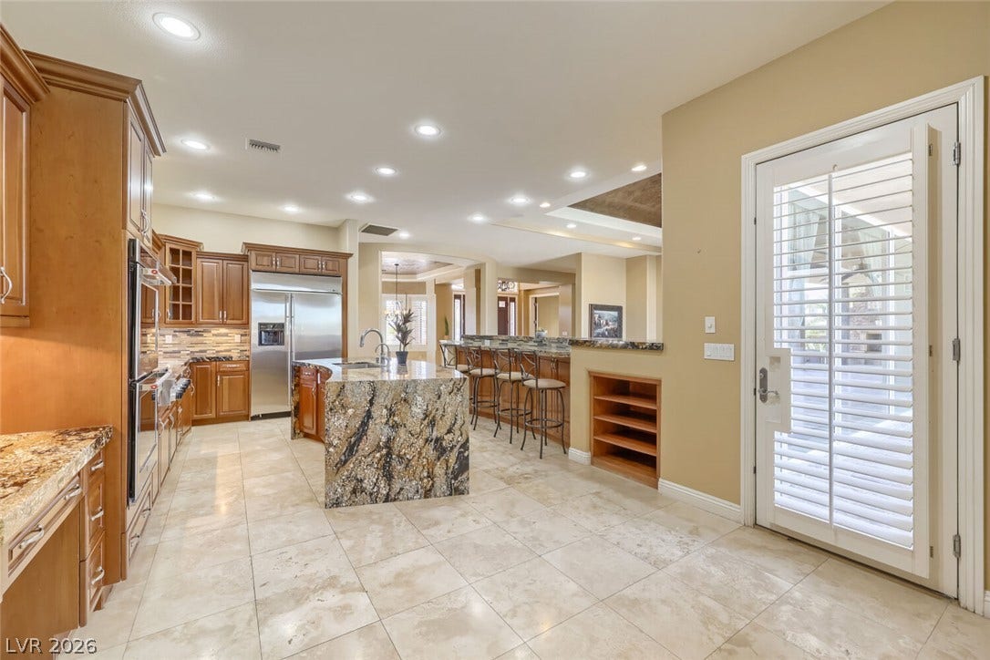 2807 Richmar Avenue, Henderson, NV 89074 Gleaming tile floors and granite countertops define this open cooking space.