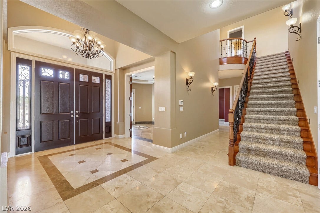 2807 Richmar Avenue, Henderson, NV 89074 An inviting entryway presents polished tile floors, high ceilings, and a carpeted staircase.