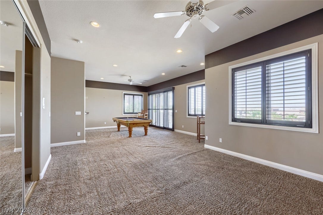 2807 Richmar Avenue, Henderson, NV 89074 An open and versatile recreation space features plush carpeting and custom window shutters.