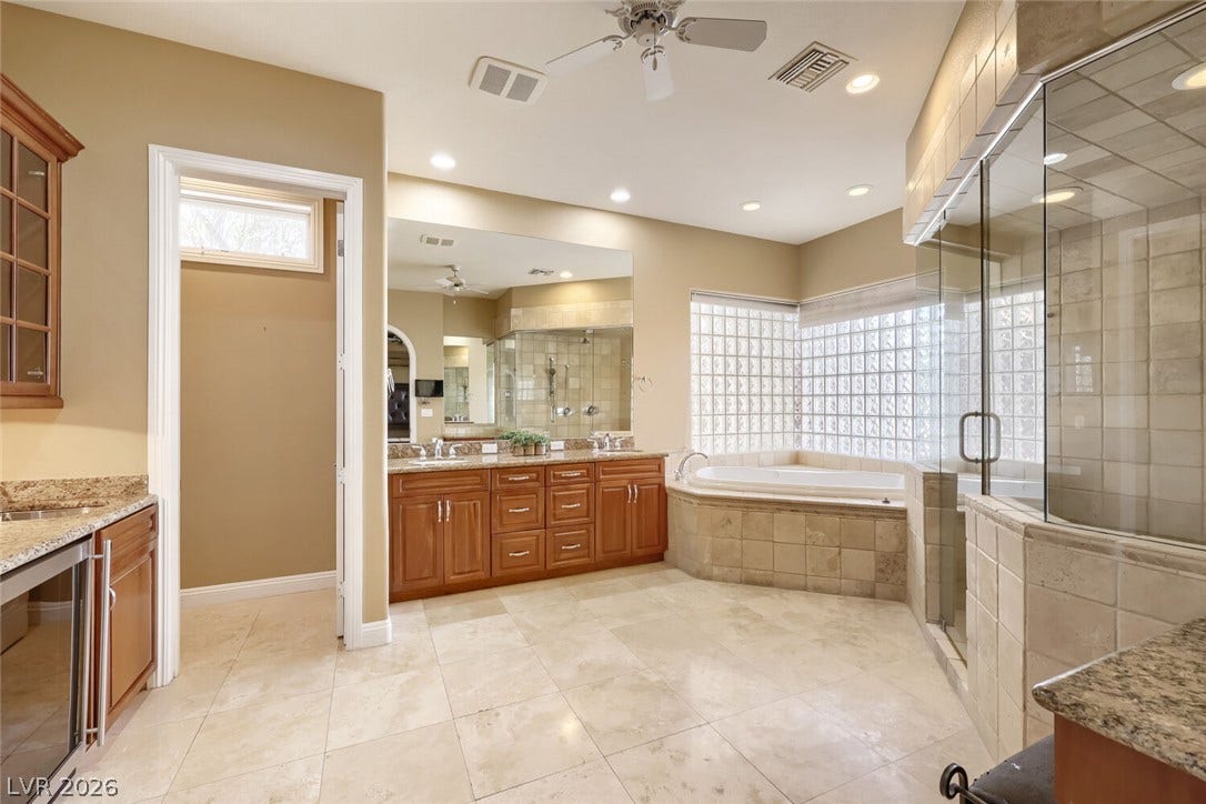 2807 Richmar Avenue, Henderson, NV 89074 Gleaming tile floors anchor this master bath featuring a soaking tub and glass-enclosed shower.
