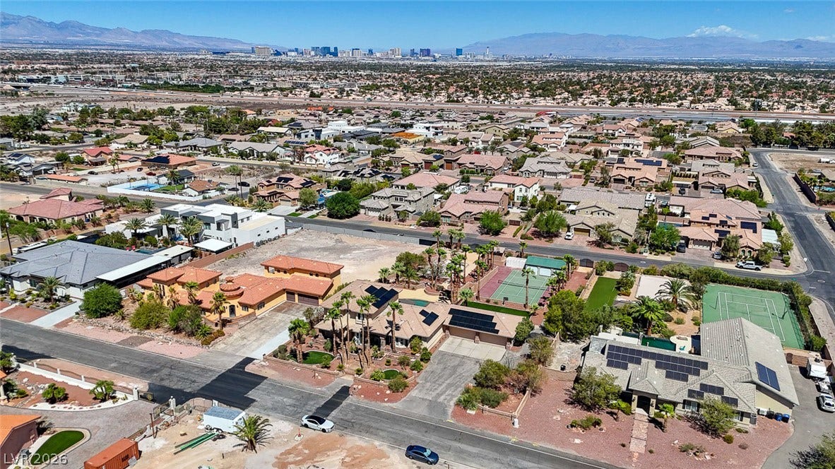 2807 Richmar Avenue, Henderson, NV 89074 An expansive neighborhood panorama captures residential streets nestled against a distant mountain skyline backdrop.