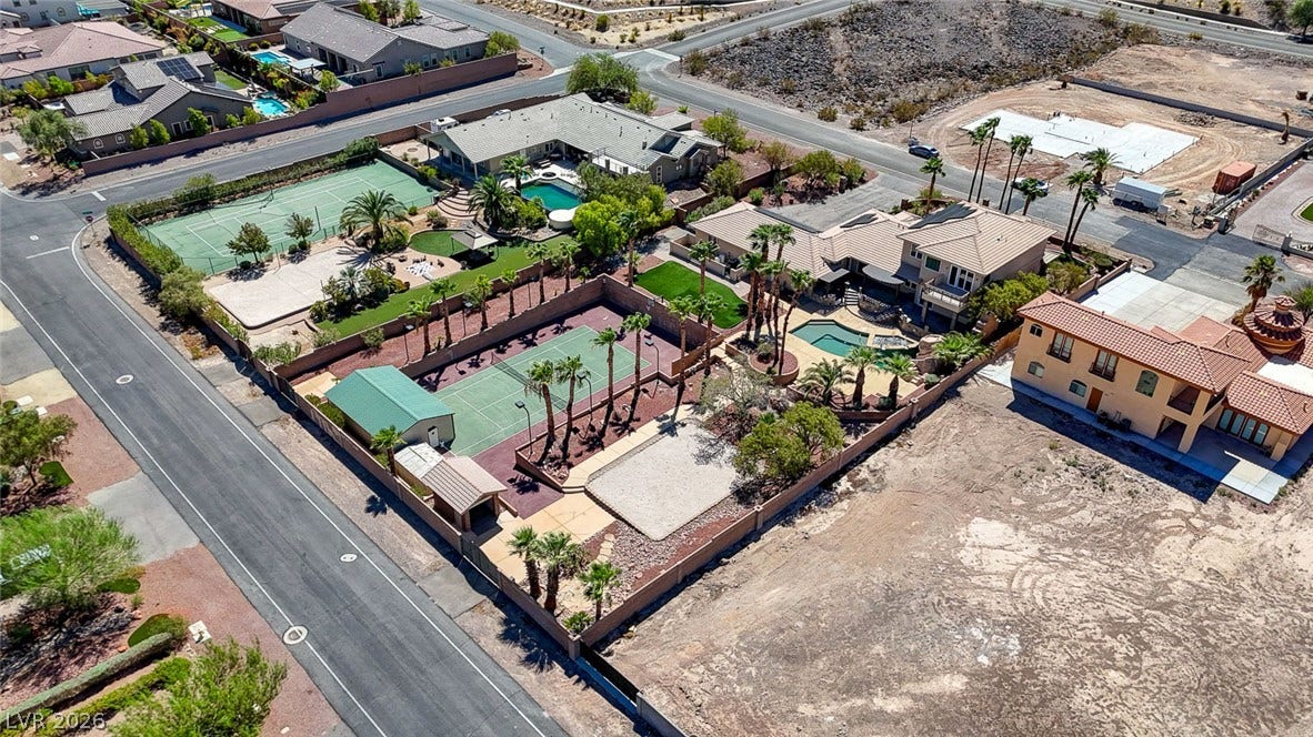 2807 Richmar Avenue, Henderson, NV 89074 Spacious residential properties enjoy private tennis courts and swimming pools along a quiet neighborhood street.