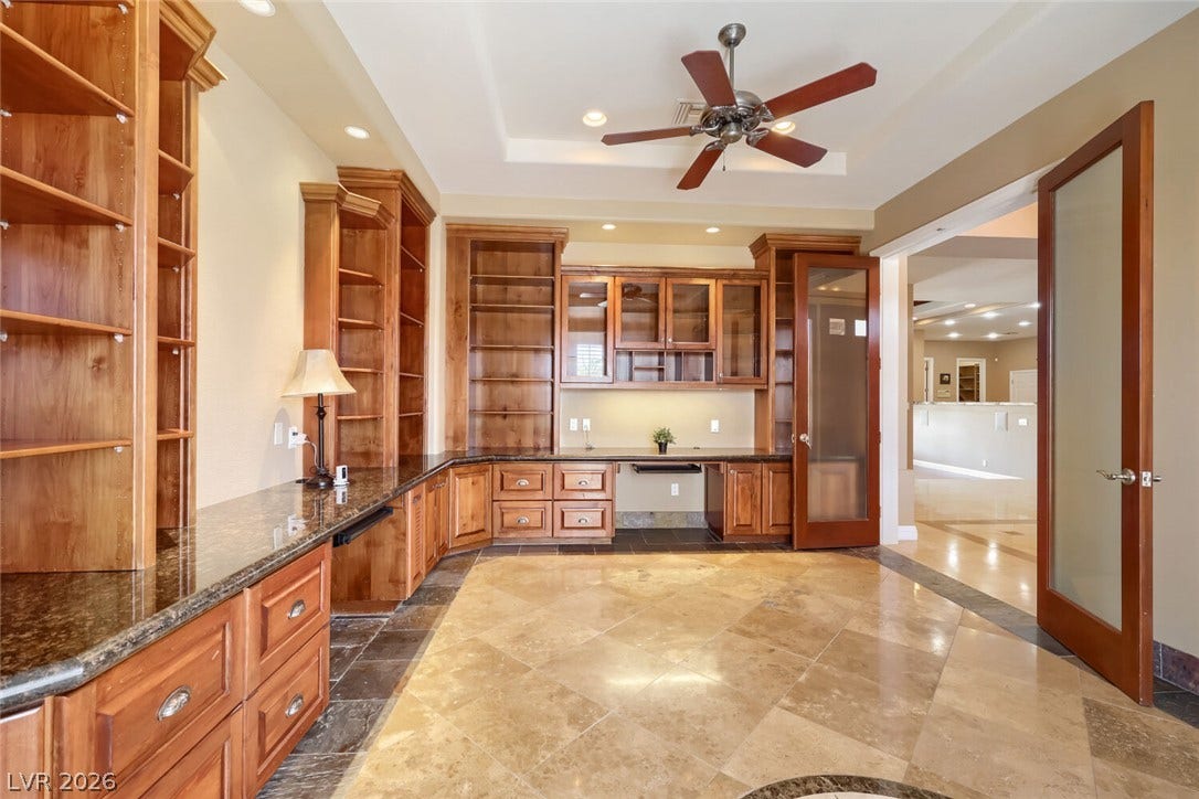 2807 Richmar Avenue, Henderson, NV 89074 Gleaming stone tile floors complement rich wood built-ins in this versatile workspace.
