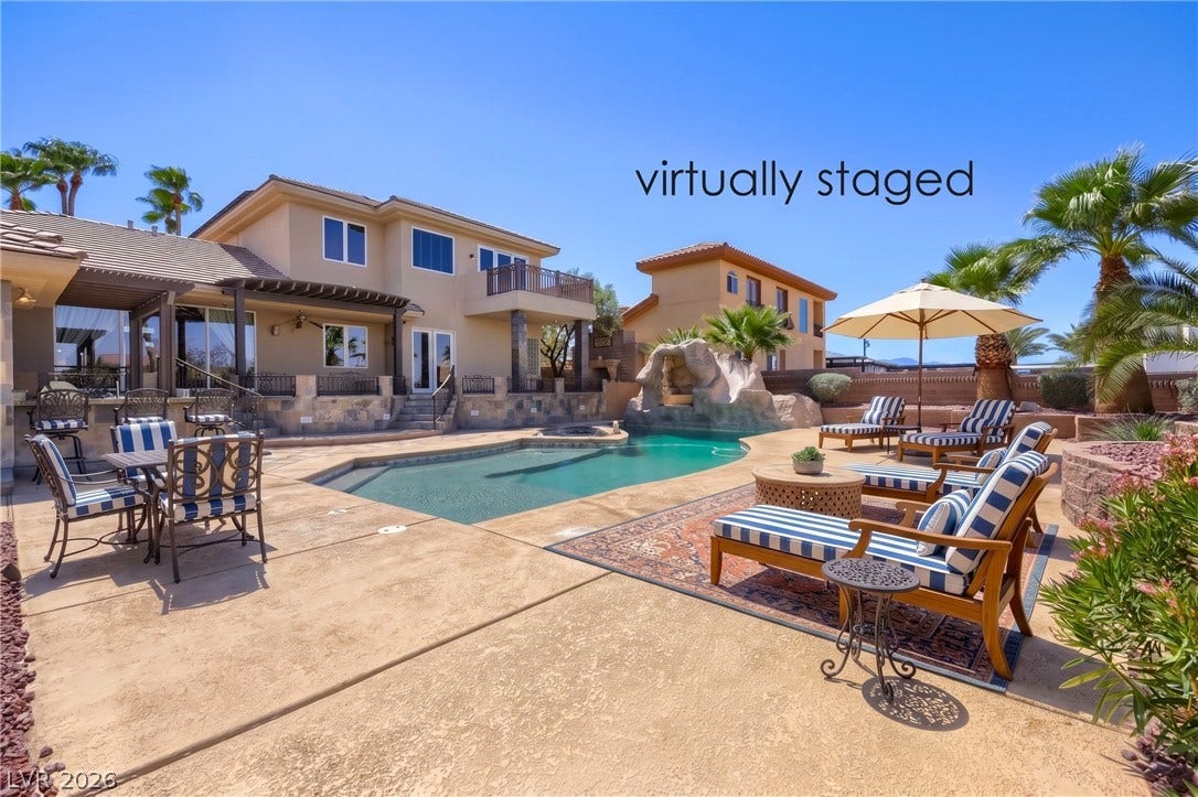 2807 Richmar Avenue, Henderson, NV 89074 An inviting backyard oasis features a custom swimming pool framed by concrete decking and palm trees.