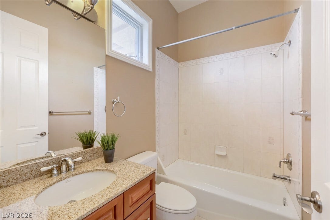2807 Richmar Avenue, Henderson, NV 89074 High ceilings and a stone counter elevate this classic full bathroom layout.