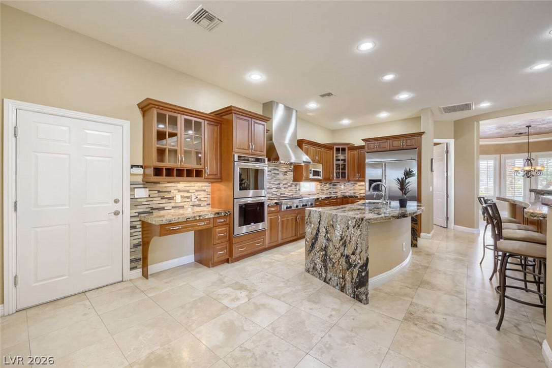 2807 Richmar Avenue, Henderson, NV 89074 Polished tile flooring and granite countertops anchor this kitchen designed with built-in appliances.