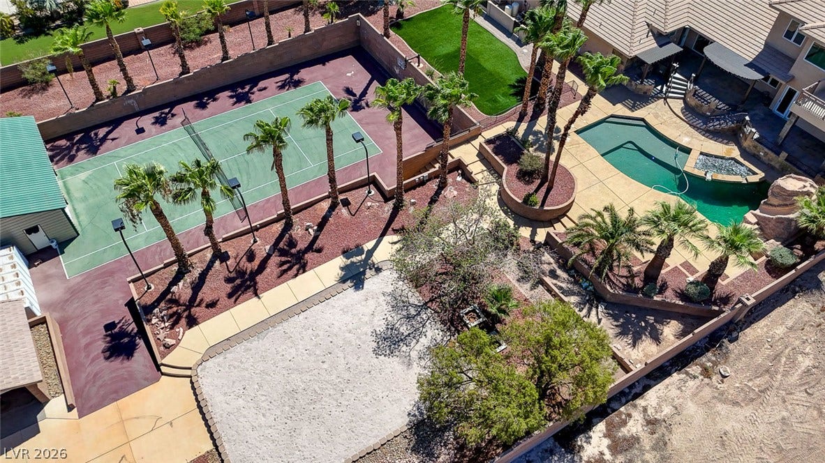 2807 Richmar Avenue, Henderson, NV 89074 An aerial perspective showcases a comprehensive backyard sports court, sand volleyball area, and swimming pool.