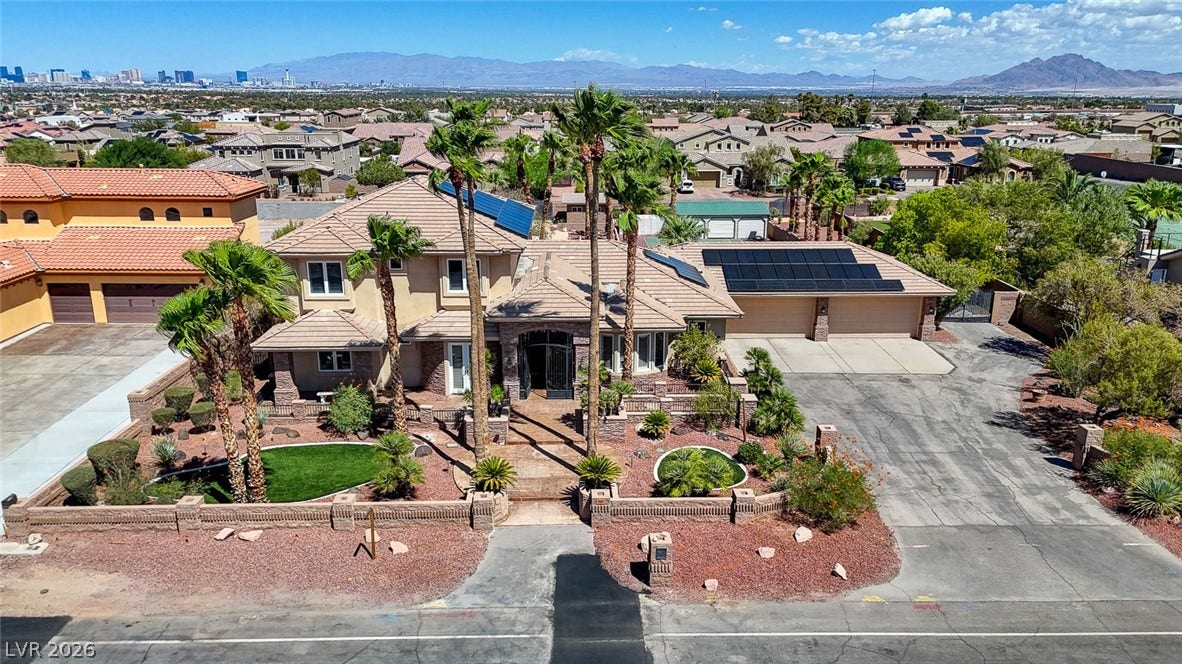 2807 Richmar Avenue, Henderson, NV 89074 An impressive multi-level estate showcases manicured desert landscaping and a tile roof.