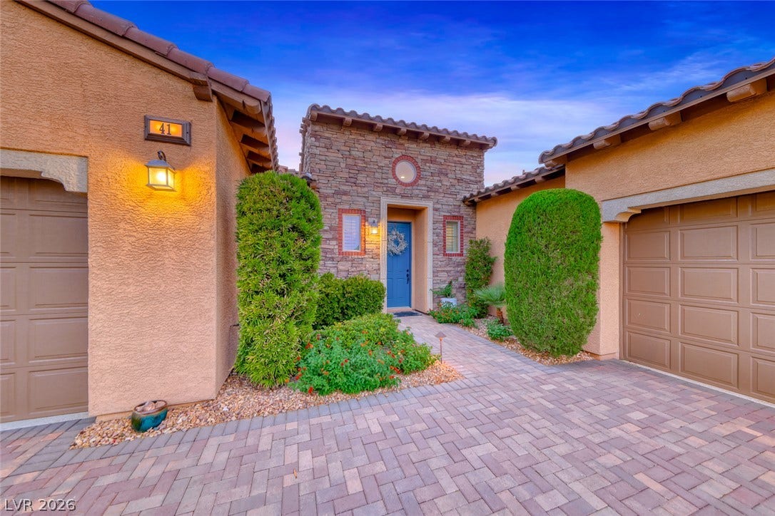 41 Moltrasio Lane, Henderson, NV 89011 An inviting stone-accented entryway features a paved path leading to the front door.