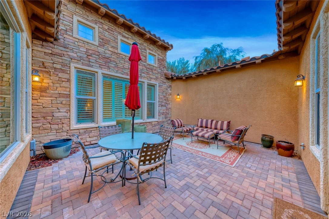 41 Moltrasio Lane, Henderson, NV 89011 An inviting stone-accented courtyard features warm brick pavers and tile roofing detail.