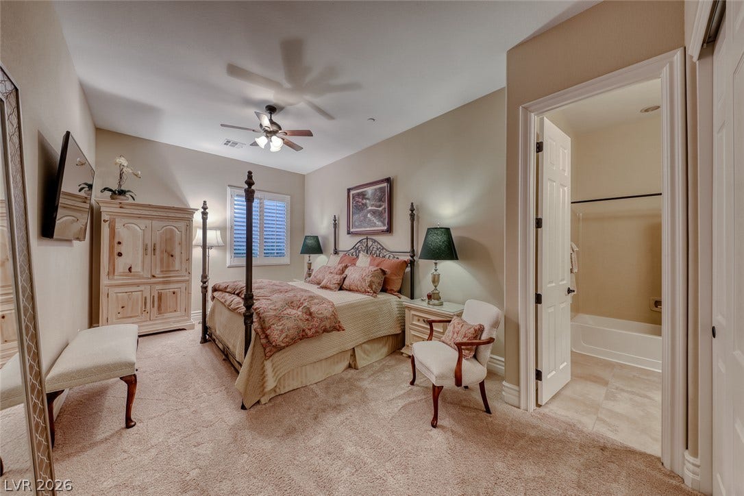 41 Moltrasio Lane, Henderson, NV 89011 A spacious bedroom offers plush carpeting and an en-suite bath.