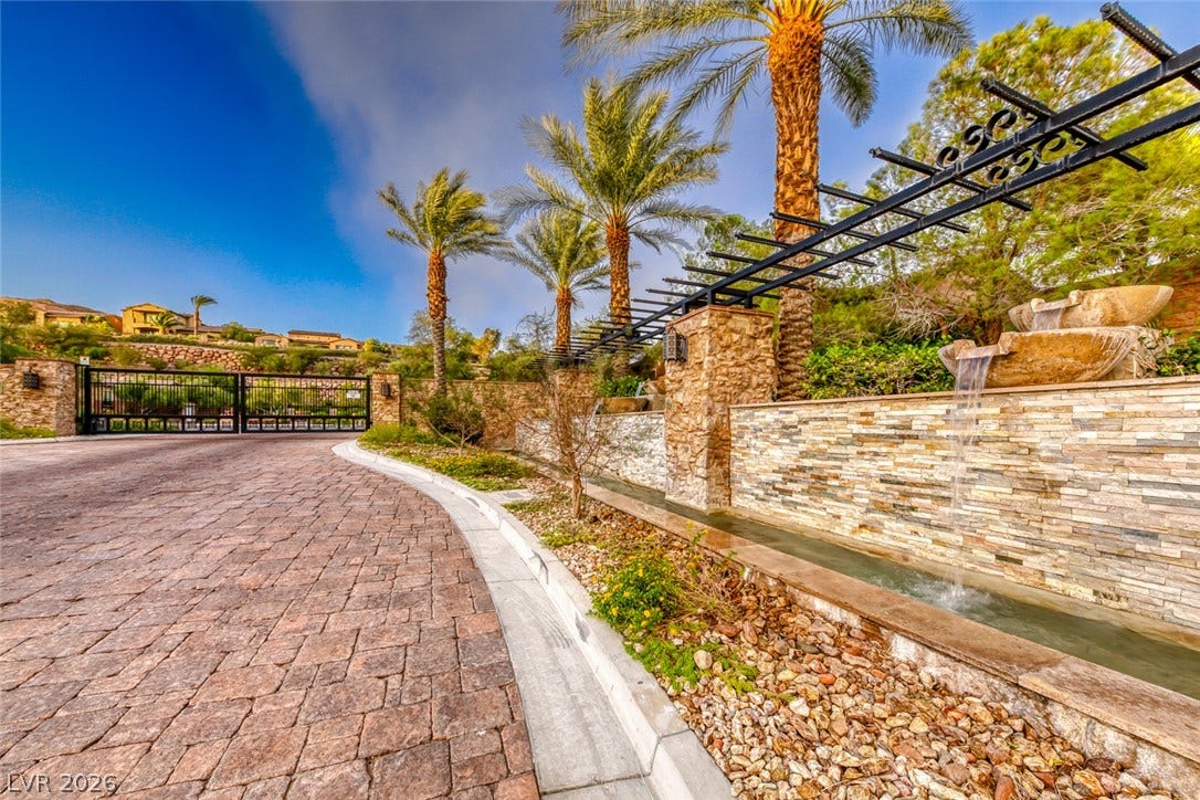 41 Moltrasio Lane, Henderson, NV 89011 A gated entry path winds past manicured palms and cascading stone water features.