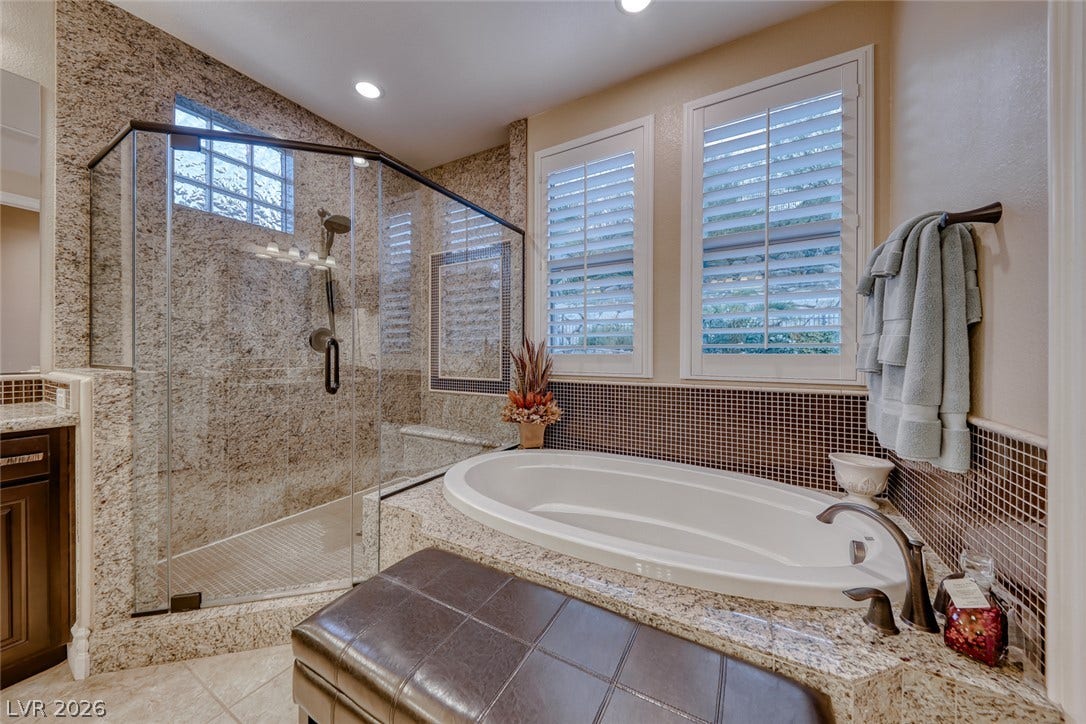 41 Moltrasio Lane, Henderson, NV 89011 Fine stone surfaces and a deep soaking tub highlight this spa-like bathroom retreat.