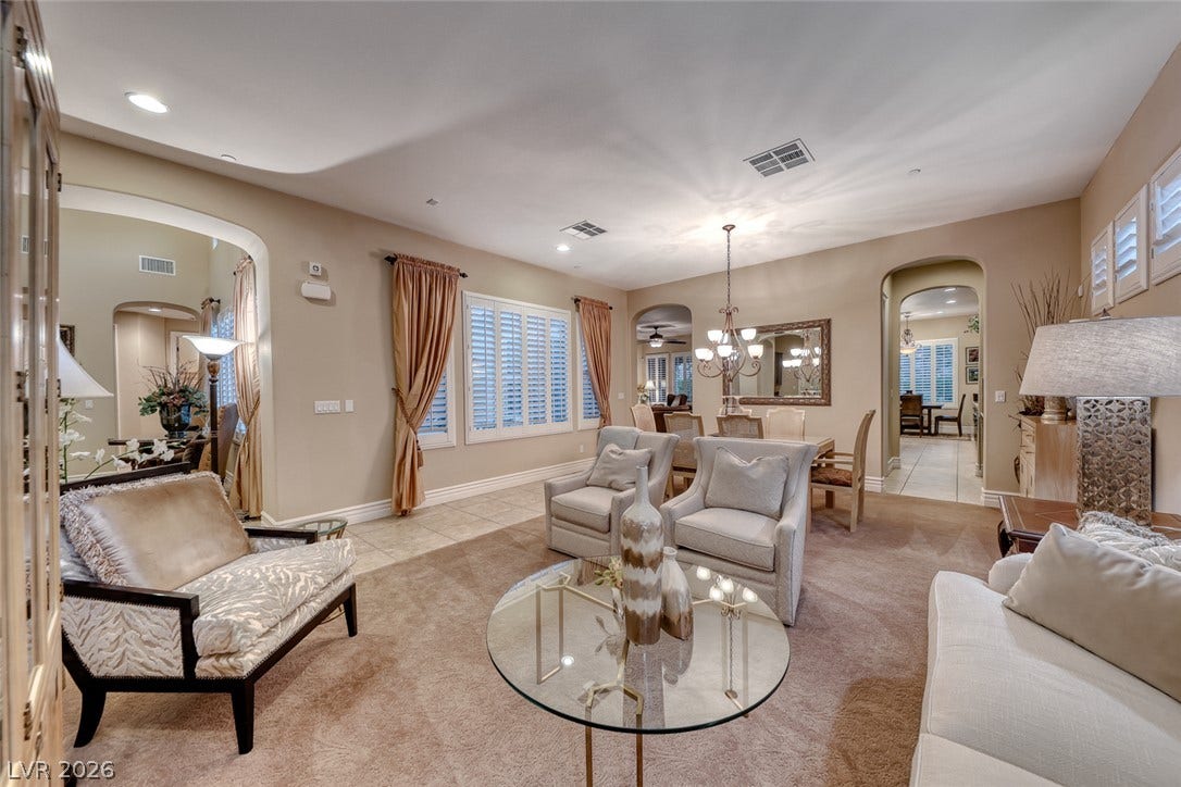 41 Moltrasio Lane, Henderson, NV 89011 Arched doorways and dual flooring textures define this comfortable, open living space.