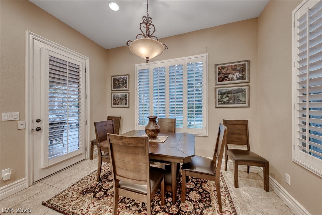 41 Moltrasio Lane, Henderson, NV 89011 Tiled floors and elegant plantation shutters define this inviting dining space with terrace access.