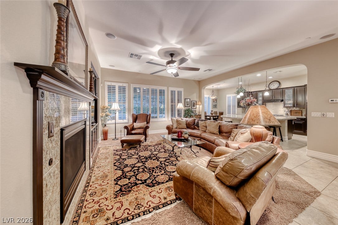 41 Moltrasio Lane, Henderson, NV 89011 An inviting open floor plan connects the tiled living space with a classic fireplace.