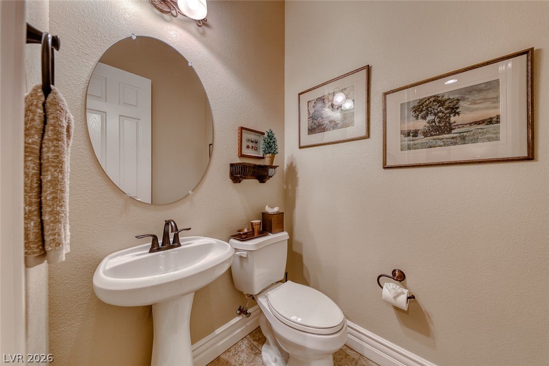 41 Moltrasio Lane, Henderson, NV 89011 High ceilings and neutral finishes define this classic powder room with a pedestal sink.