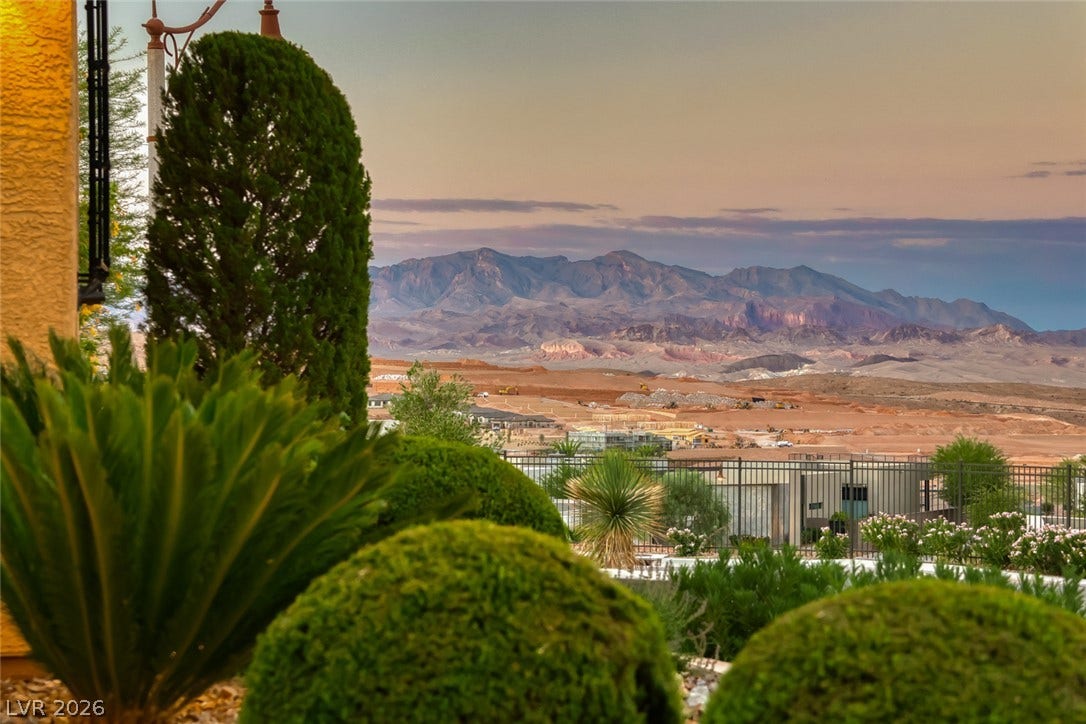 41 Moltrasio Lane, Henderson, NV 89011 Majestic mountain ridges rise beyond manicured desert plantings and neighborhood fencing.