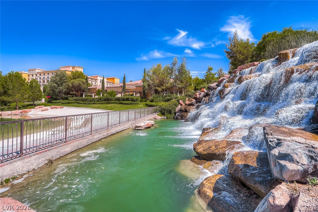 41 Moltrasio Lane, Henderson, NV 89011 A magnificent cascading stone waterfall feeds into a serene private canal bordering the manicured grounds.