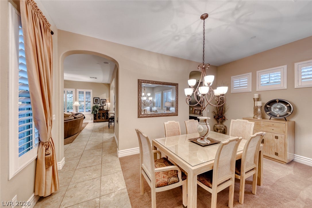 41 Moltrasio Lane, Henderson, NV 89011 An arched doorway connects the formal dining area to a tile-floored hallway.