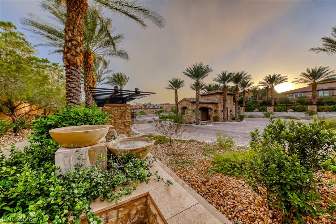 41 Moltrasio Lane, Henderson, NV 89011 Lush desert landscaping and stone architectural accents create a grand gated entrance.